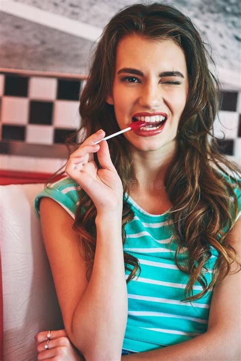 Shes Sweet Like Candy A Beautiful Young Woman In A Diner Stock Photo