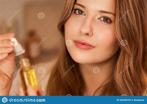 Beautiful Woman With Organic Oil Serum Bottle Evening Beauty And Skincare Routine Stock Image