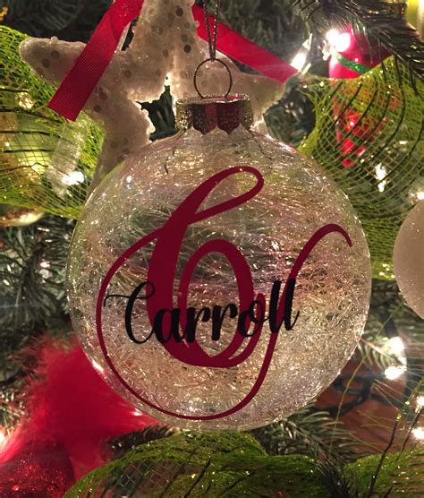 A Glass Ornament With The Number Six On It Hanging From A Christmas Tree