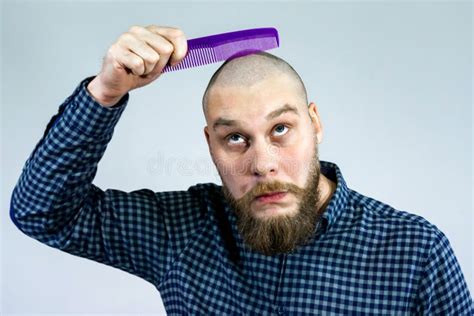 Portrait Of Sad Bearded Bald Man Hold Comb In His Hand The Concept Of