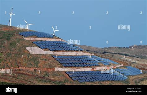 Photovoltaics Solar Panels And Wind Turbines Generating Electricity On