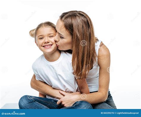 Mother Hugging And Kissing Smiling Daughter Stock Photo Image Of