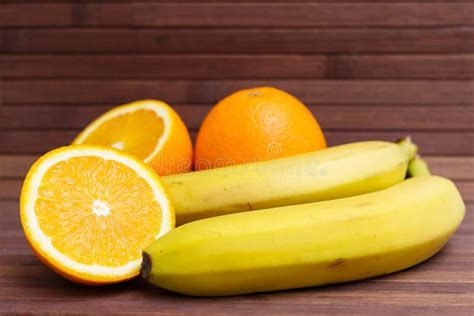 Fresh Fruits Banana Orange Isolated On Wooden Background Stock Photo