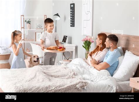 Little Children Bringing Their Parents Breakfast In Bed Stock Photo Alamy