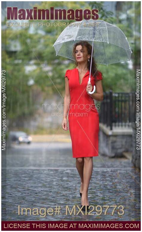 Photo Of Woman In Red Dress With Umbrella Walking In The Rain On The