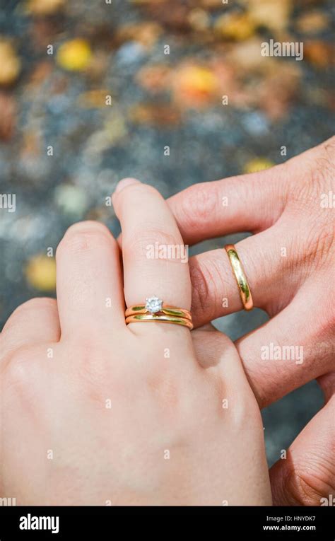 Husband And Wife Hands With Marriage Wedding Rings On Fingers Stock