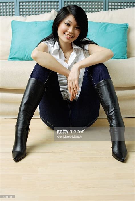 Stock Photo Young Woman Sitting On Floor Legs Apart Hands On Knees