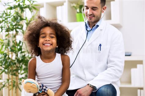 African American Female Doctor Examining Girl Stock Photo Image Of