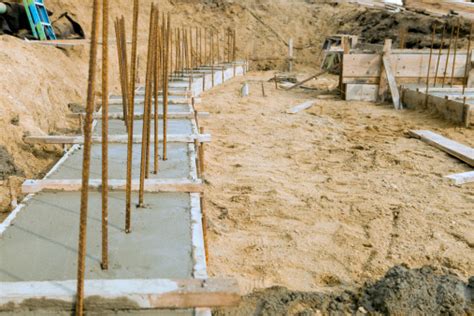 Freshly Poured Concrete Retaining Wall Footings With Rebar Stock Photo