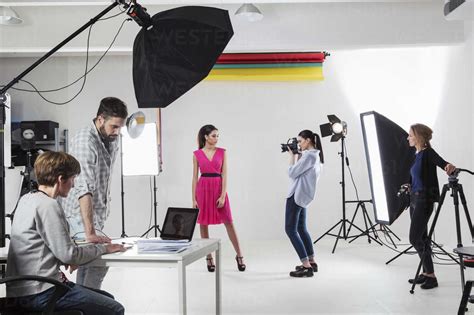 Photographer Photographing Fashion Model In White Backdrop Photography