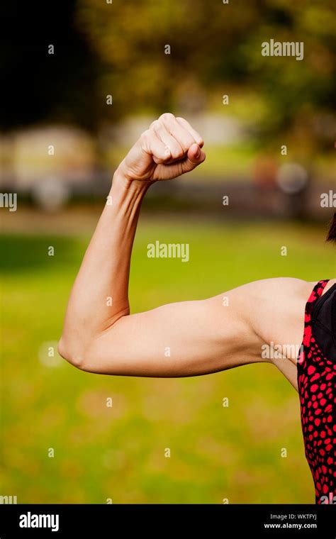 A Female Flexing Her Bicep Muscle Stock Photo Alamy