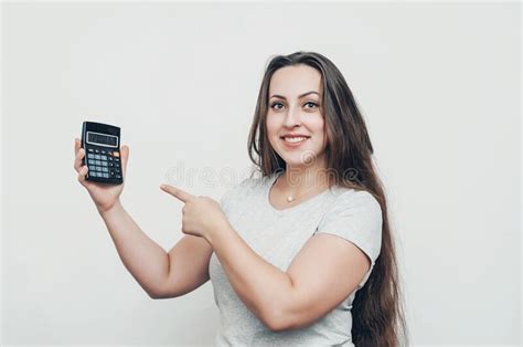 Joyful Girl With Long Hair Pokes Her Finger At The Calculator Stock