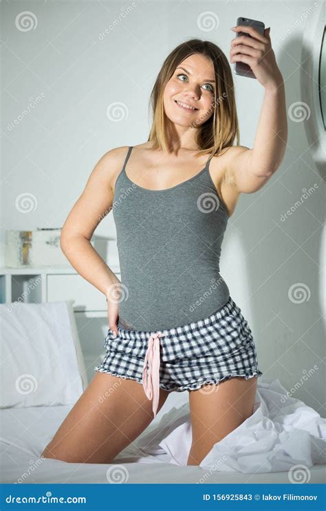 Teenage Girl Smiling In Camera And Making Selfie In Bed Stock Image Image Of Casual Caucasian
