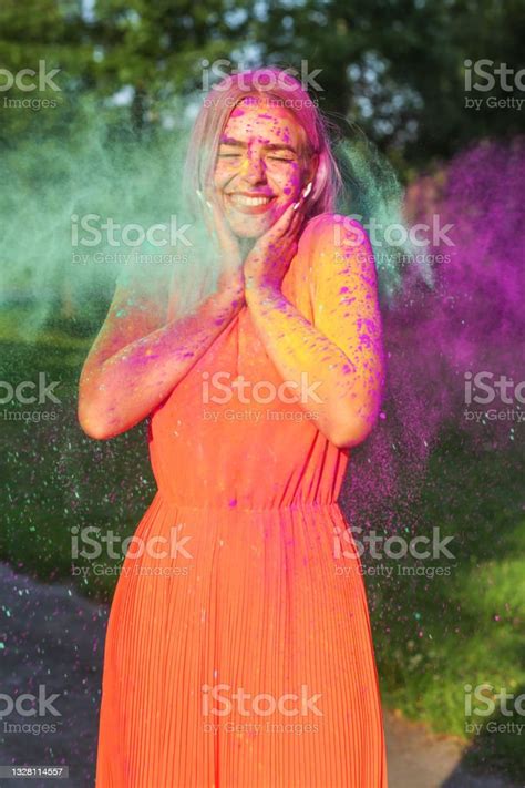 Positive Blonde Woman With Long Hair Posing With Exploding Purple And
