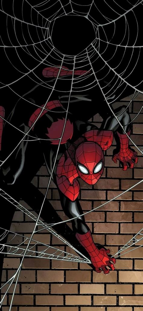 A Spider Man Hanging From A Web In Front Of A Brick Wall With His