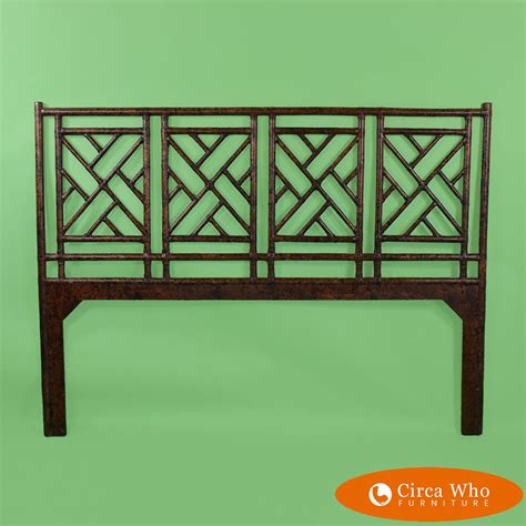 The Headboard Is Made Out Of Wood And Has An Intricate Design On Its Sides
