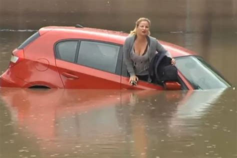 agile woman deftly escapes onto car roof during flood