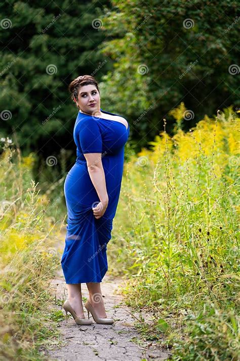 Plus Size Model In Blue Dress With A Deep Neckline Outdoors Beautiful Fat Woman With Big