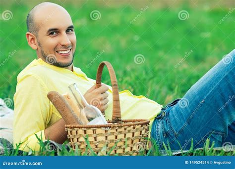 Weekend Picnic Concept Portrait Of A Young Handsome Bald Man In Trendy Clothes Lying On Green