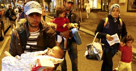 Refugees Arrive In Austria From Hungary As Desperate Migrant Families