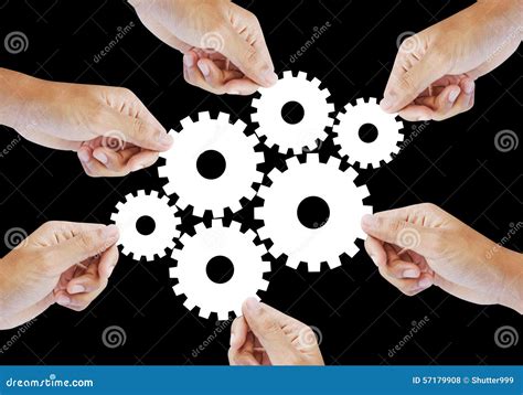 Teamwork Works Together To Build A Cog Wheel Gear System Stock Photo