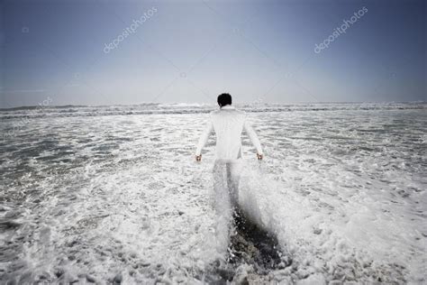 Man Walking Into Sea — Stock Photo © Londondeposit 33827401