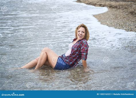 Wet Girl Sitting In The Water On The Sea Beach Stock Photo Image Of