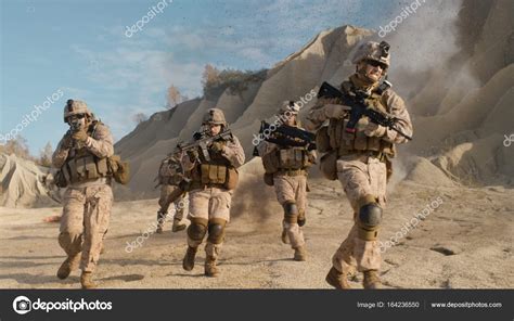 Squad Of Fully Equipped Armed Soldiers Running And Attacking Du Stock