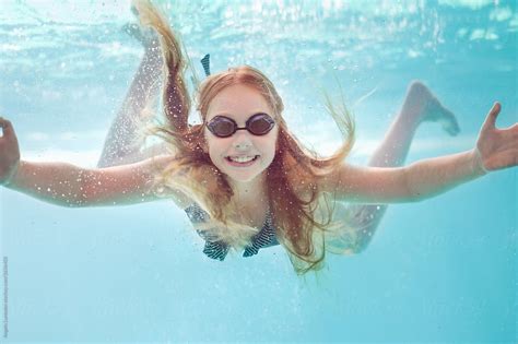 Smiling Girl With Swimming Goggles Underwater In A Pool By Angela Lumsden