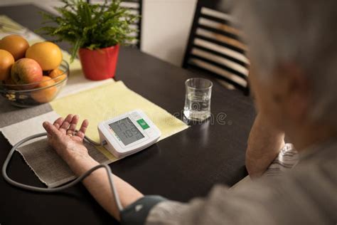 Senior Woman Measuring Blood Pressure Showing Very High Values Stock