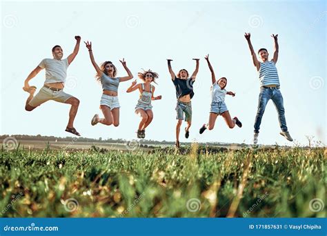 Group Of Friends Jumping In The Park Stock Image Image Of Environment