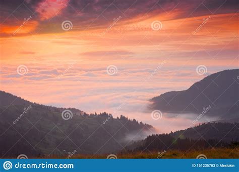 Mountain Peaks Above The Clouds At Sunset Stock Image Image Of Mist