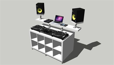 A Djs Desk With Two Laptops And Speakers