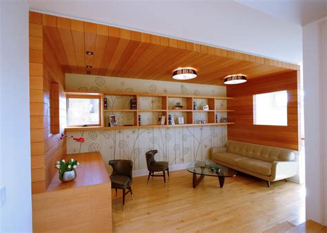 Cozy Home Office And Library With Contemporary Wood Paneling