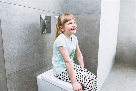 Premium Photo Cheerful Girl Sitting On Toilet