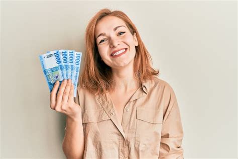 Young Caucasian Woman Holding Hungarian Forint Banknotes Looking Positive And Happy Standing And