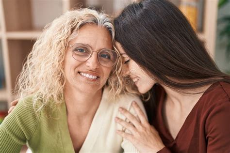 Two Women Mother And Daughter Hugging Each Other At Home Stock Image