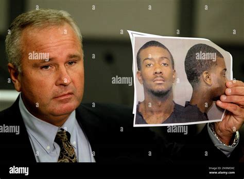 Auburn Police Chief Tommy Dawson holds up a photo of Desmonte Leonard