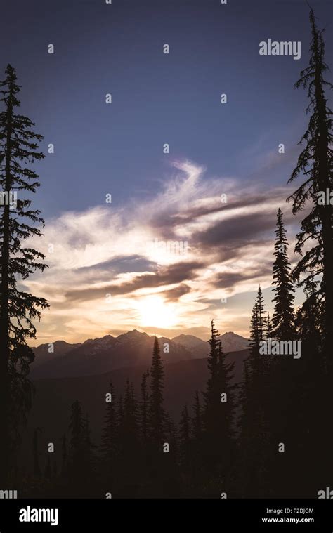 Sun Rising Over Rocky Mountain Range Stock Photo Alamy