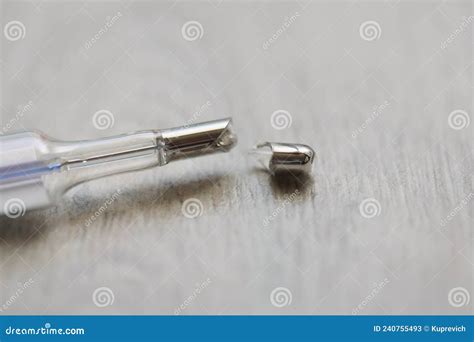 Broken Mercury Thermometer On A Gray Background Blurry Stock Image