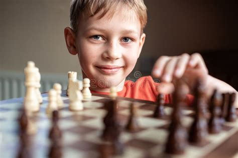 Young White Child Playing A Game Of Chess On Large Chess Board Chess
