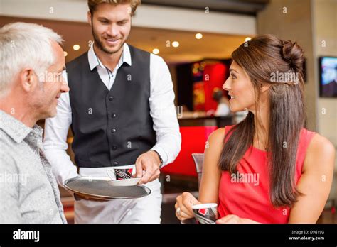 Waiter Serving Tea To A Couple In A Restaurant Stock Photo Alamy