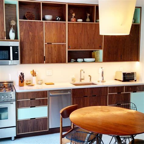 3 kitchen cabinets from ikea form the base. Walnut plywood kitchen with open cubbies by Kerf Design ...