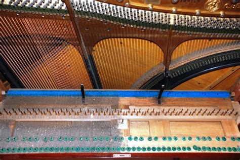Dr k tackles the brown piano in a very noisy st pancras station. David Boyce Piano Services