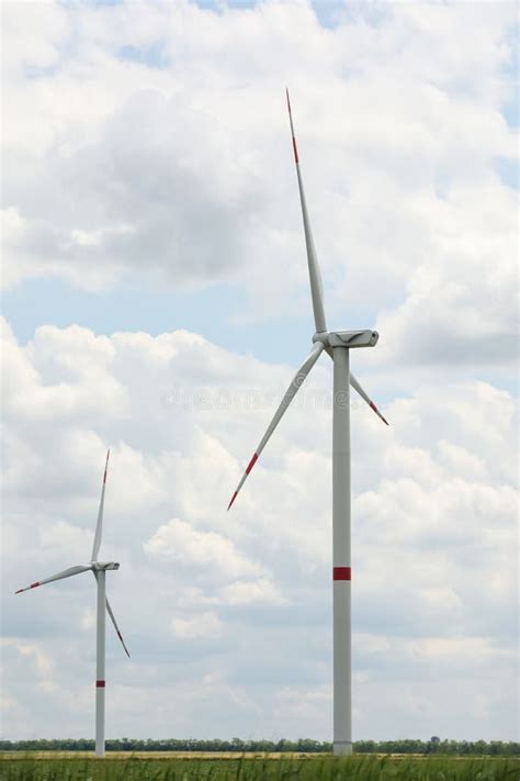 Modern Wind Turbines In Field On Day Alternative Energy Source Stock