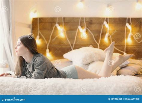 Young Girl With Long Hair Bare Legs Lay On Bed Close Up Photo On Window Background Stock Image