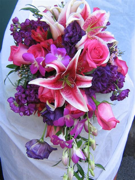 flowersbysnellings cascade bouquet of fresh stargazer lilies purple lisianthus hot pink roses