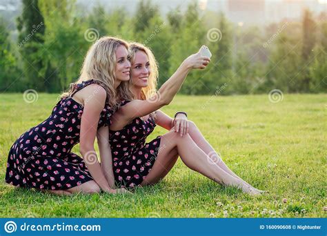 Two Funny Sisters Twins Beautiful Curly Blonde Happy Young Toothy Smile Woman In Stylish Dress
