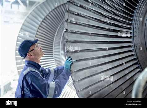 Close Up Of Engineer Inspecting Low Pressure Turbine During Inspection