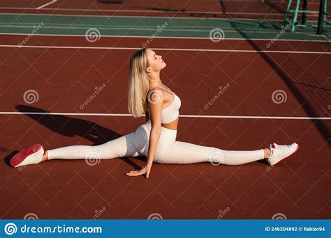 Fit Blonde Girl Does Front Leg Spirit Workout Exercise Outdoor